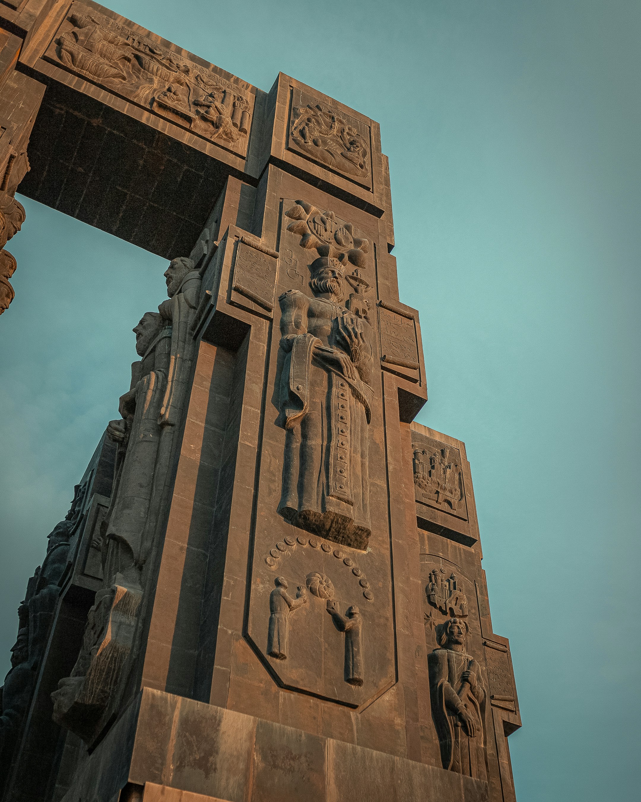 un'alta torre con statue su di essa contro un cielo azzurro