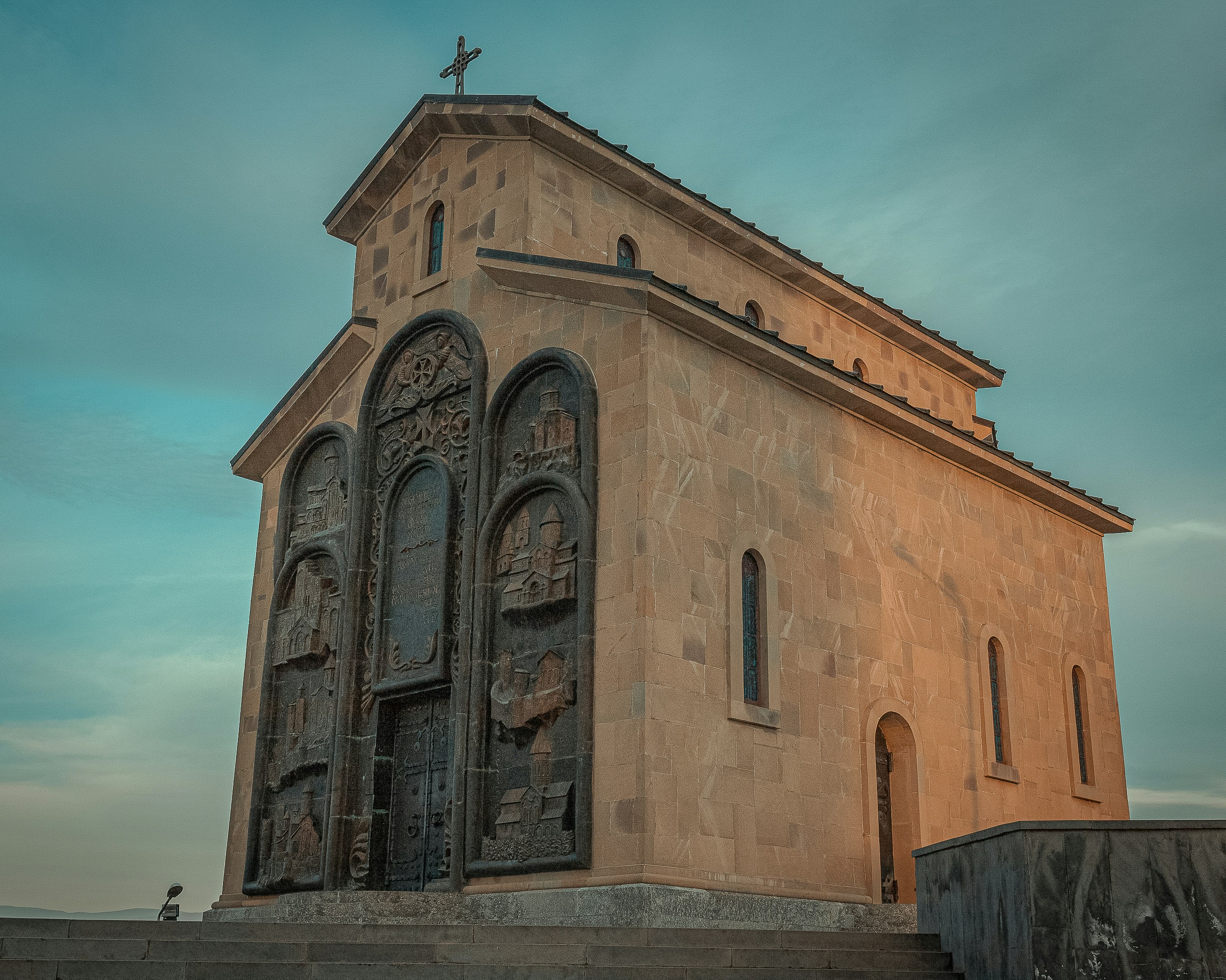 a tall building with a cross on top of it