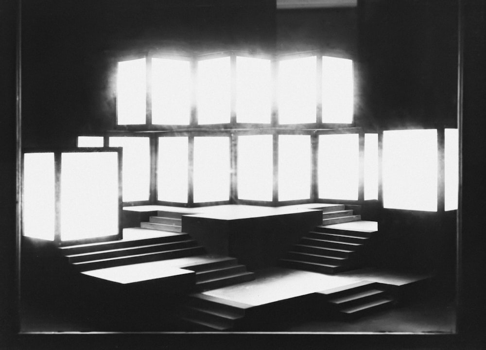 a black and white photo of a room with windows