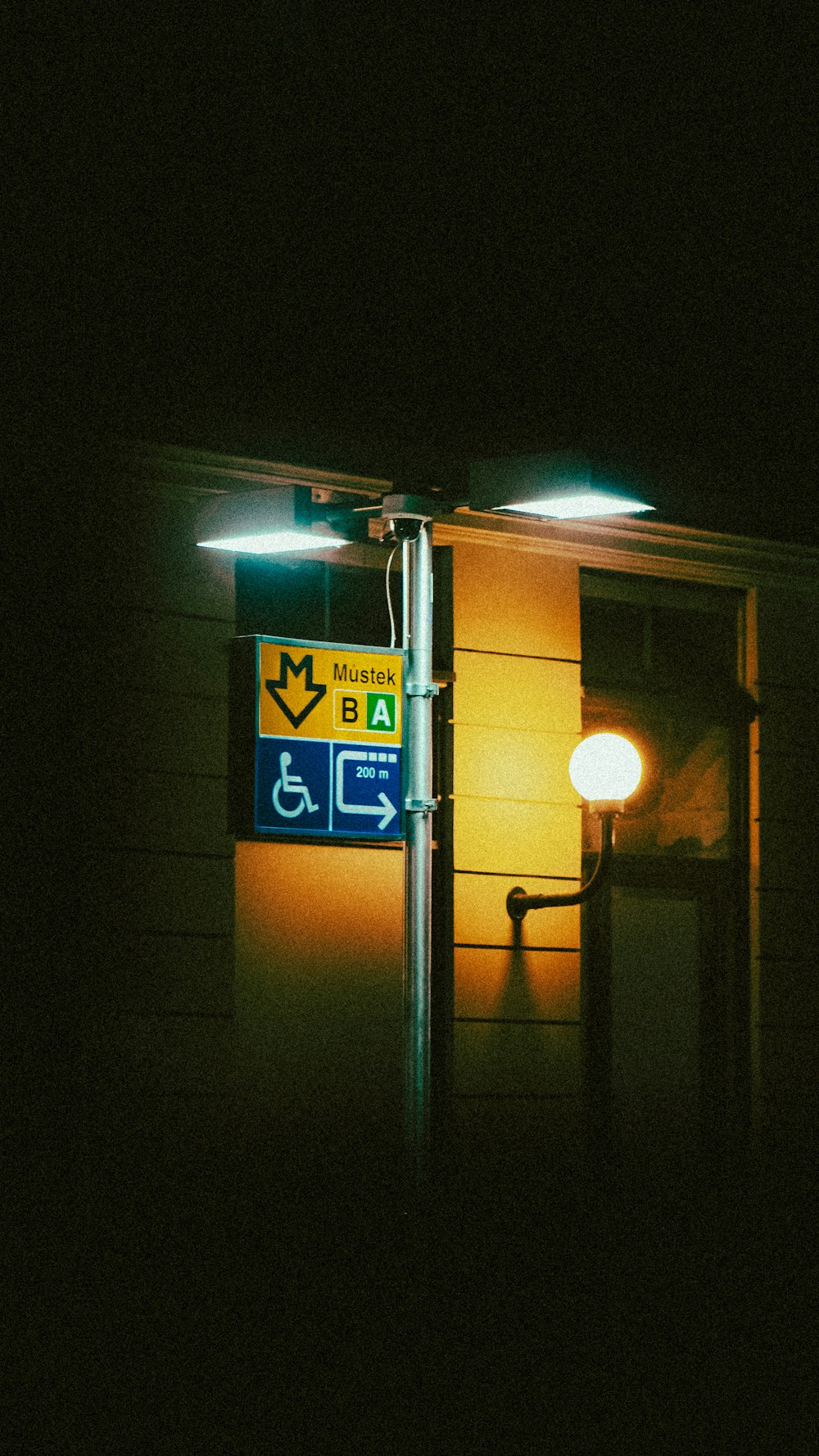a street sign is lit up at night