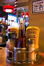 a basket of condiments sits on a counter in a restaurant