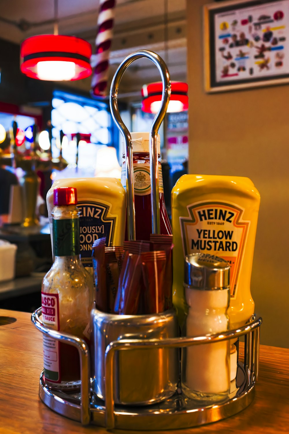 a basket of condiments sits on a counter in a restaurant