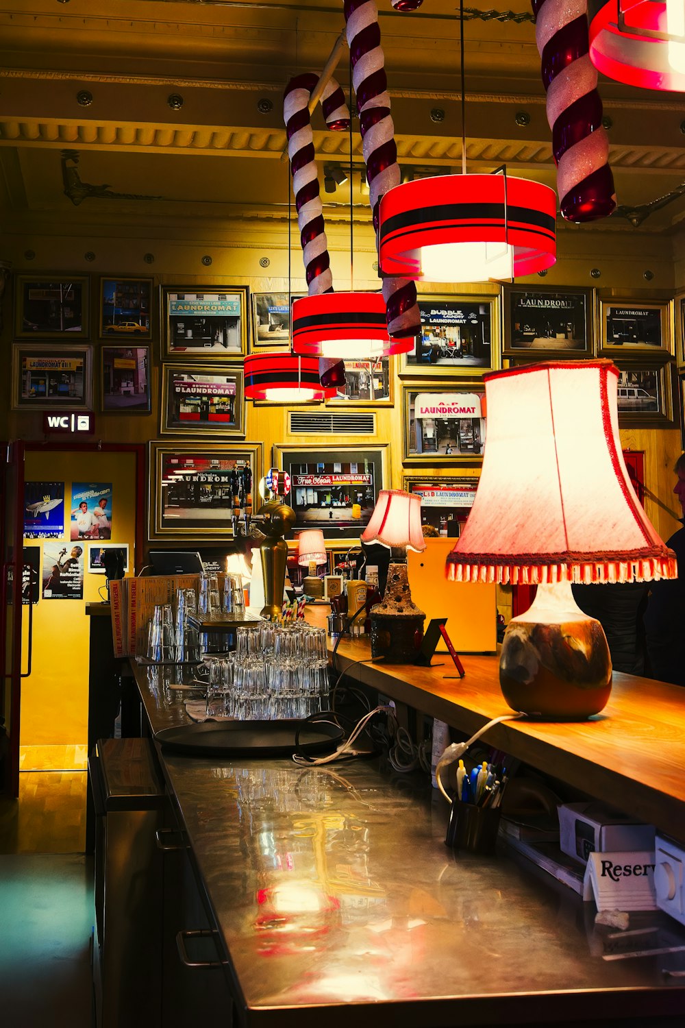 a bar with a lot of lamps hanging from the ceiling