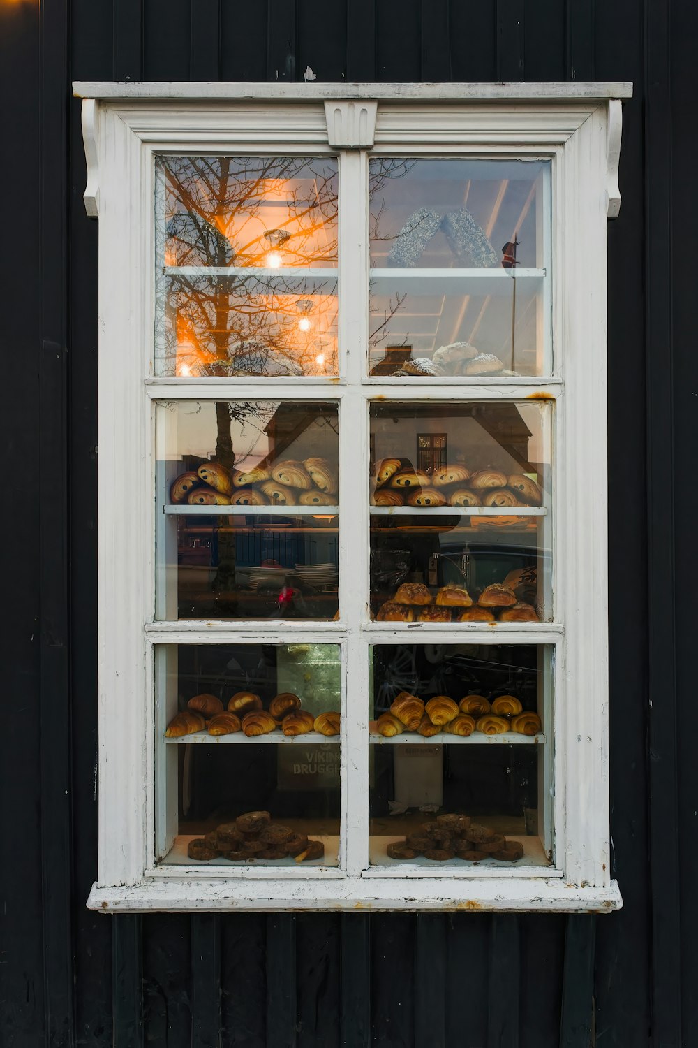 a window that has a bunch of pastries in it