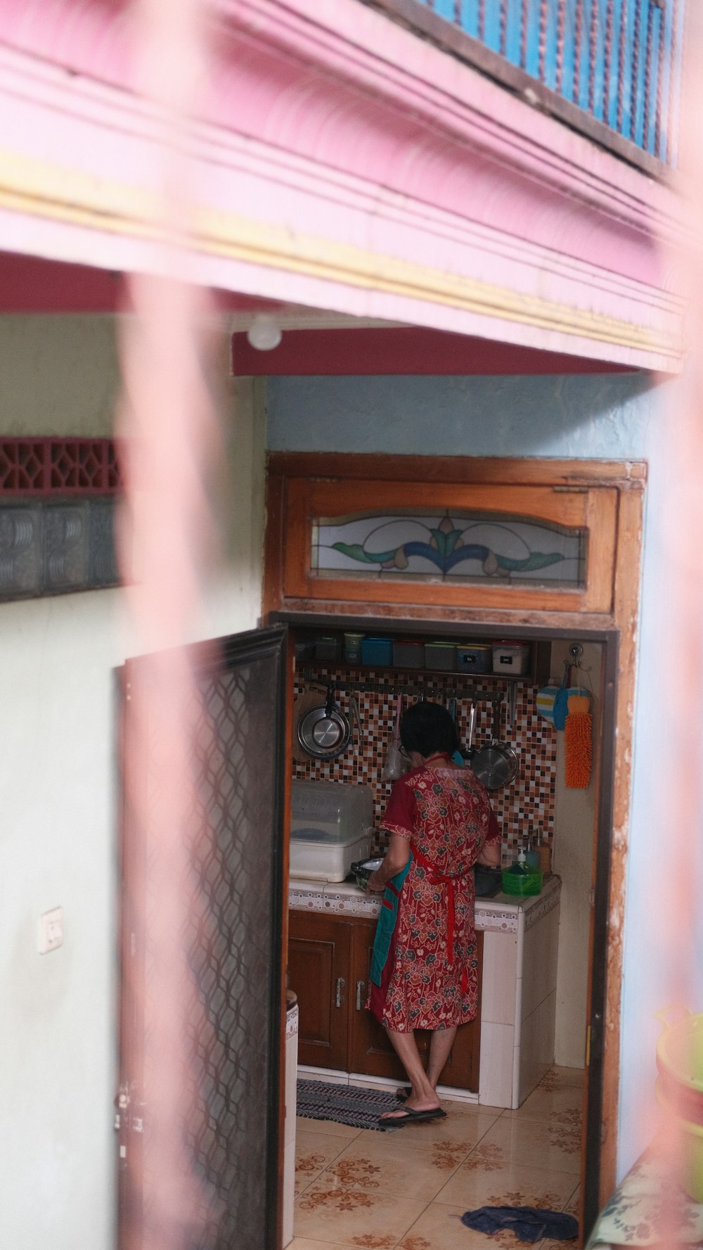 a woman standing in a doorway of a kitchen