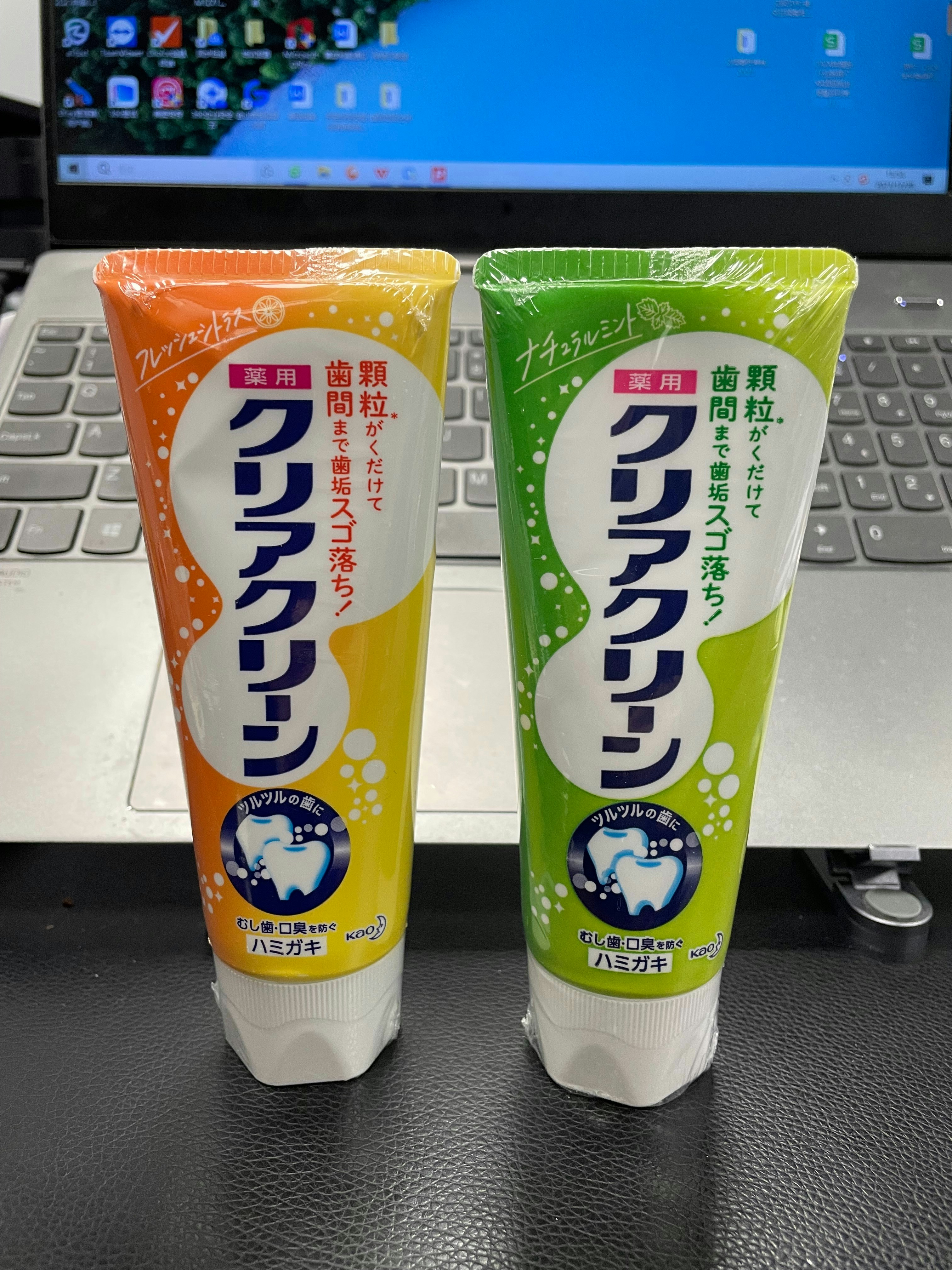 Multiple tubes of DCL Dencare toothpaste in various formulas arranged on a bright white surface