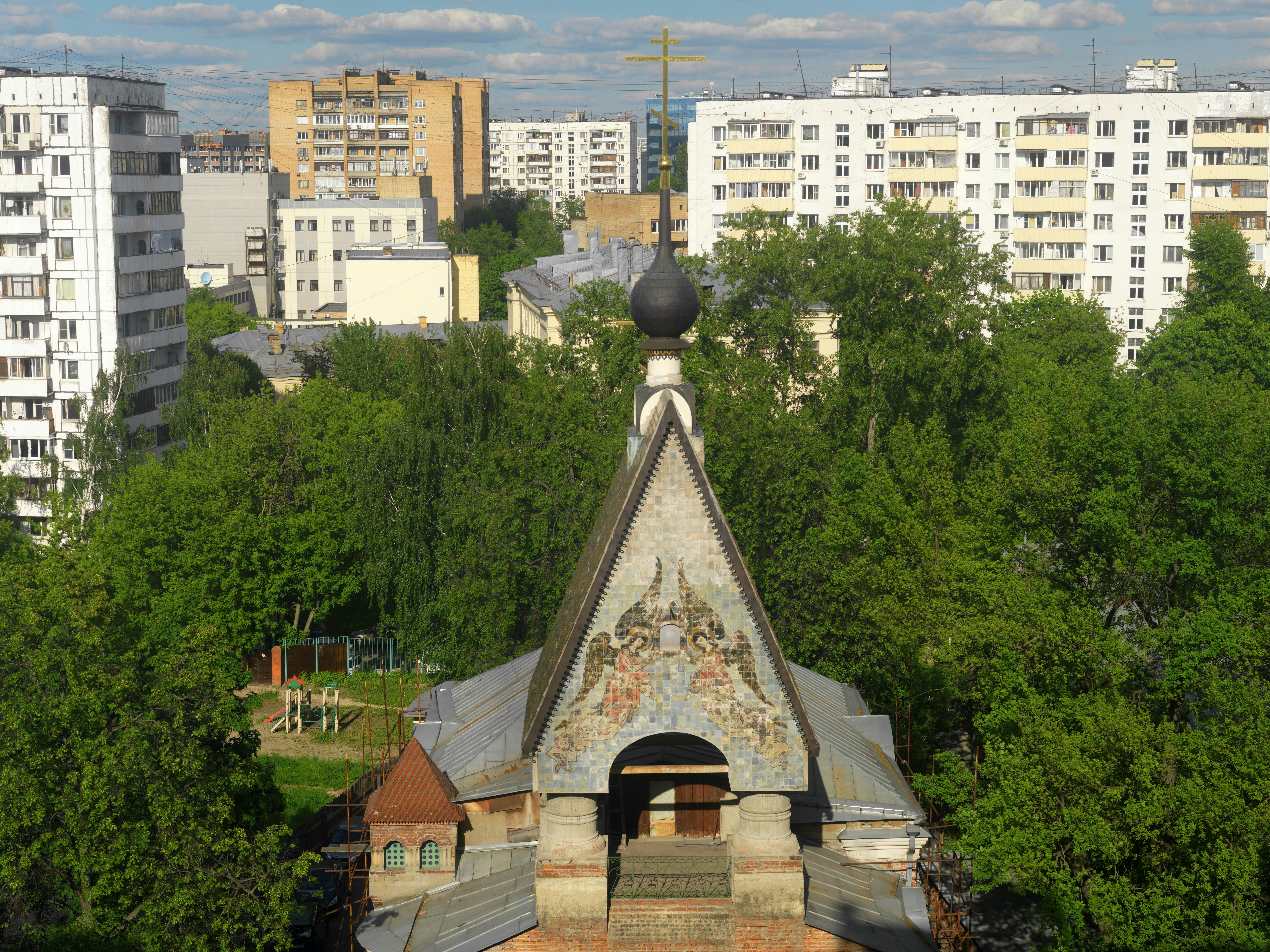a building with a steeple surrounded by trees