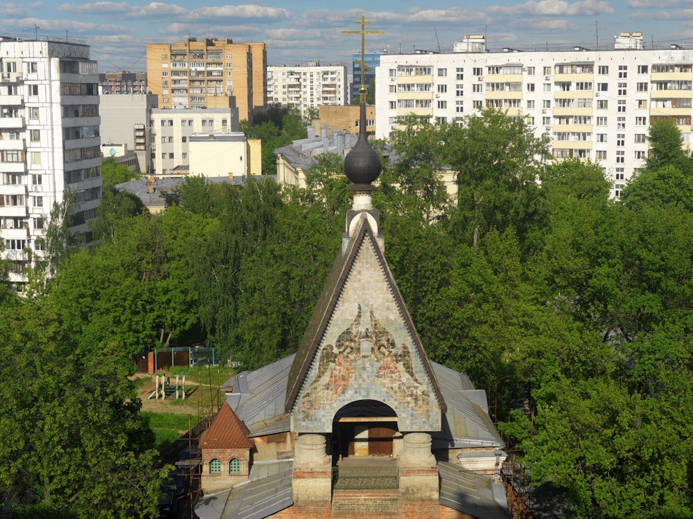 a building with a steeple surrounded by trees