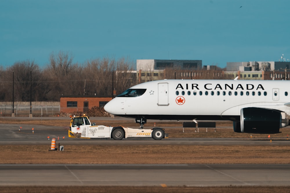 a large air canada jet sitting on top of an airport tarmac