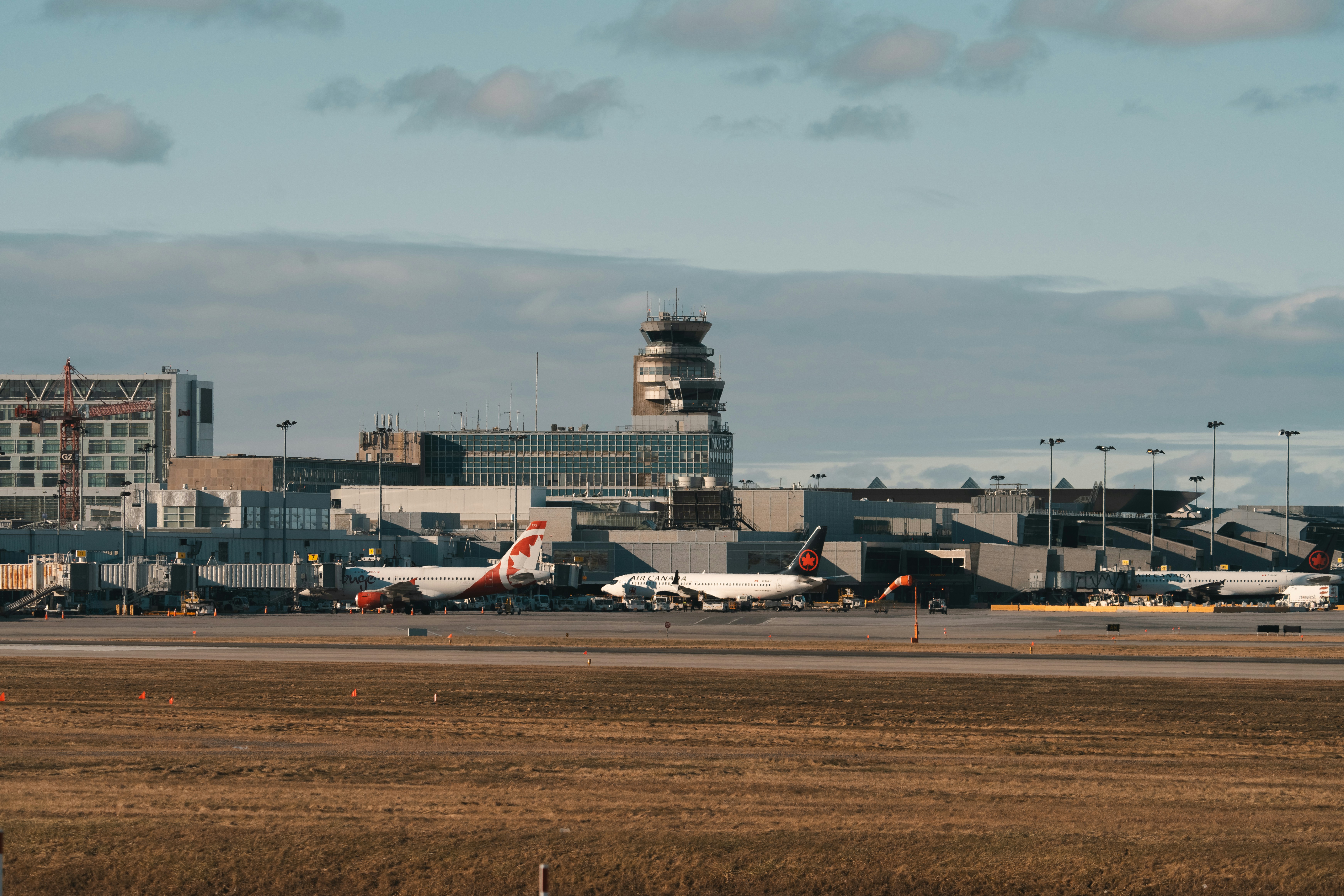 a group of airplanes parked at an airport