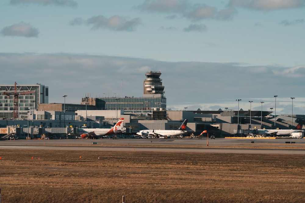 a group of airplanes parked at an airport