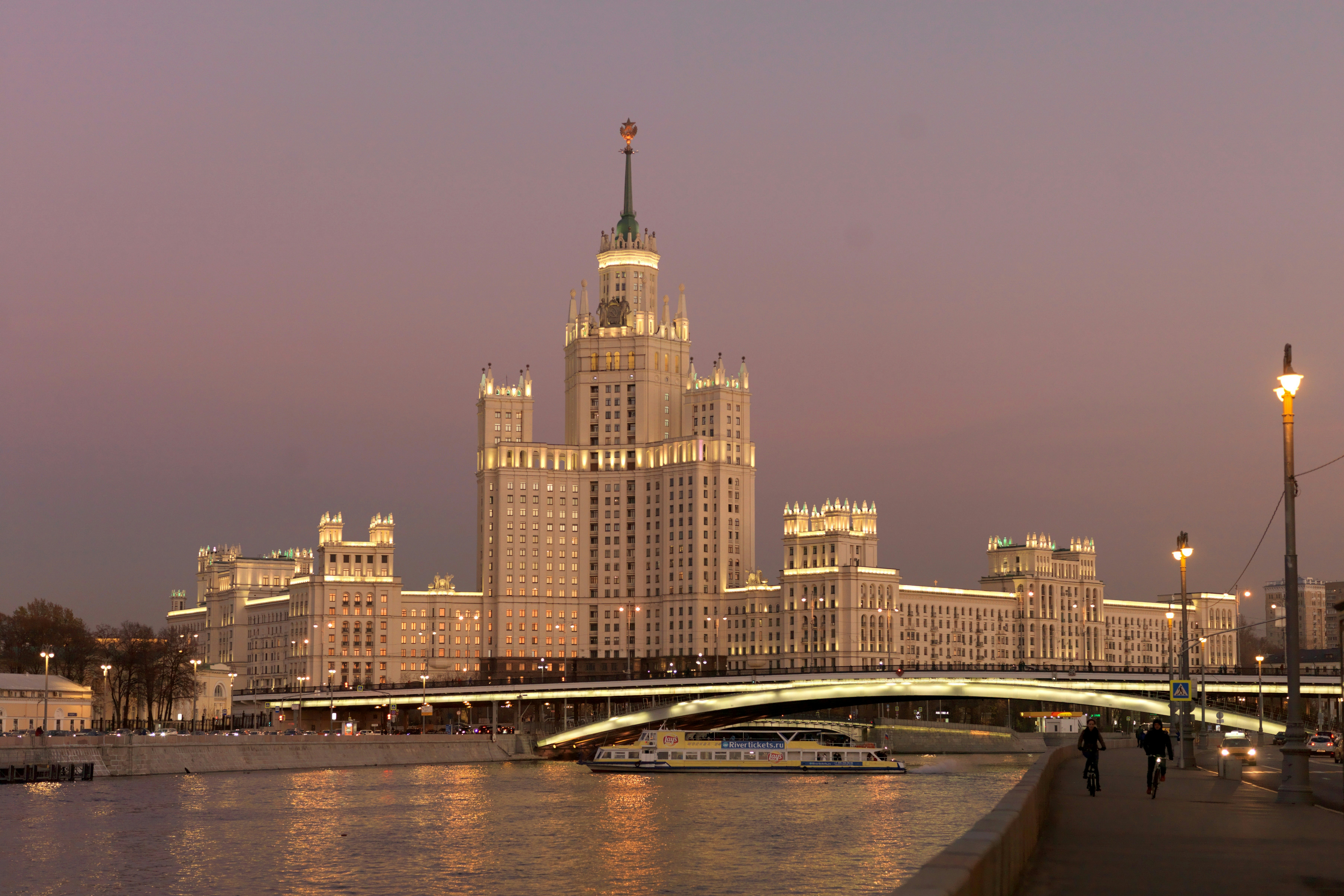 a bridge over a body of water next to a tall building