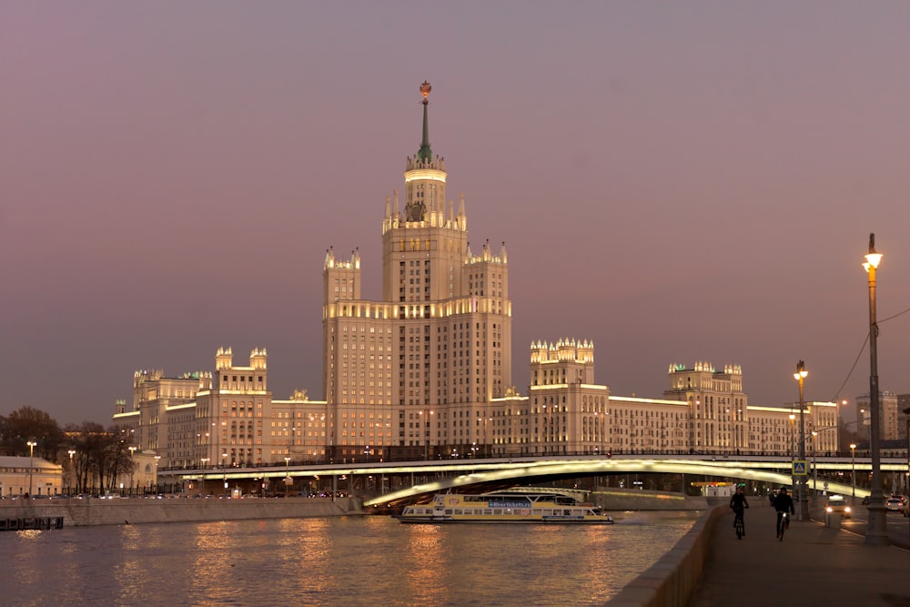 a bridge over a body of water next to a tall building