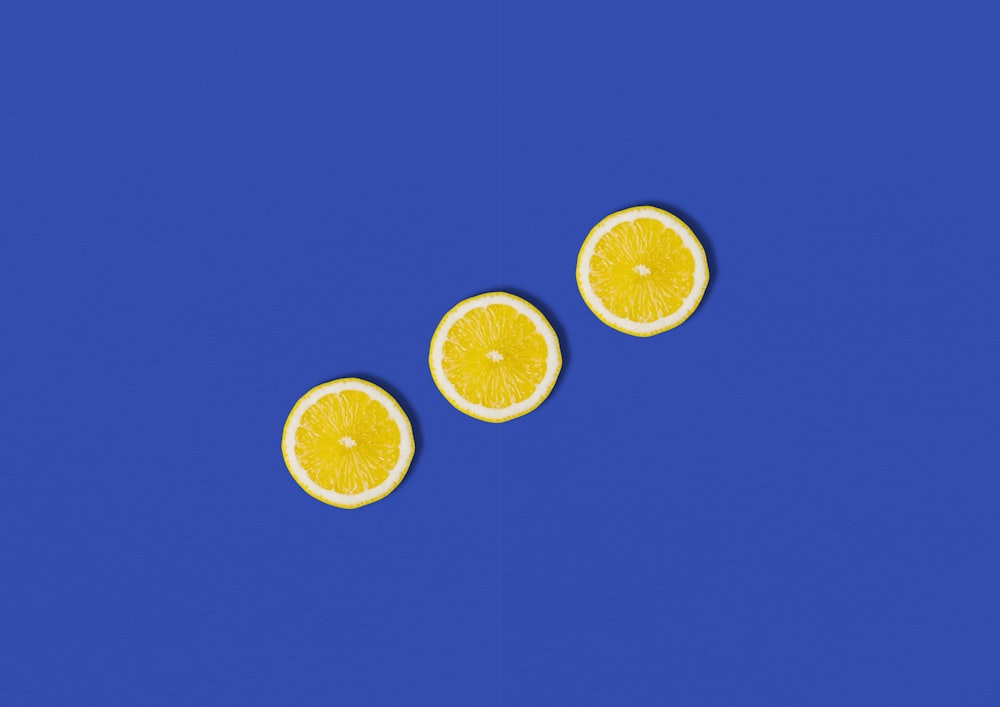 three slices of lemon on a blue background