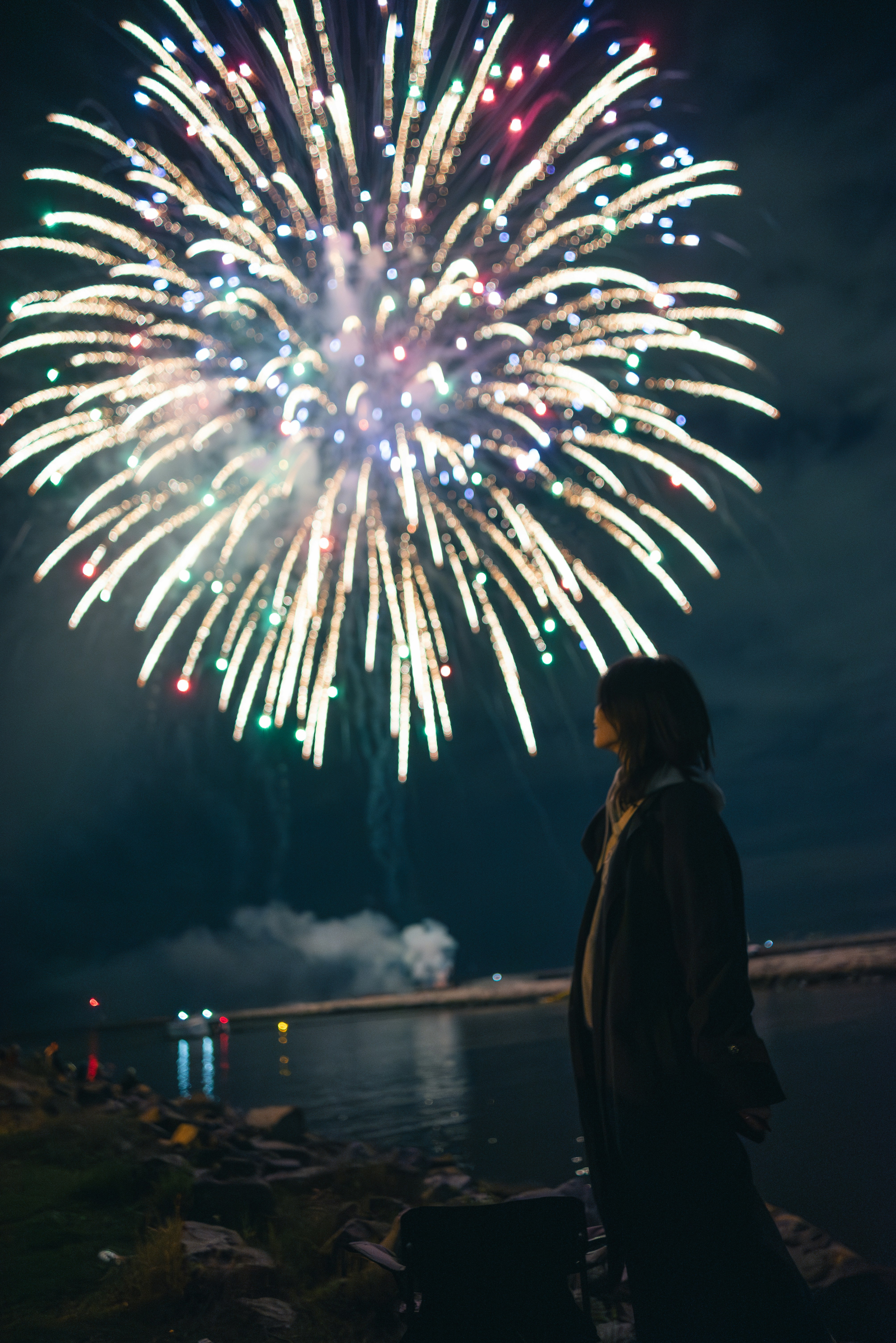 A woman standing in front of a fireworks display photo – Free Grey ...