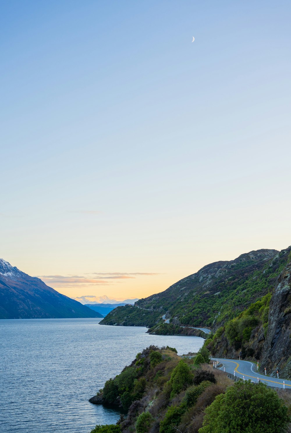 a scenic view of a mountain and a body of water