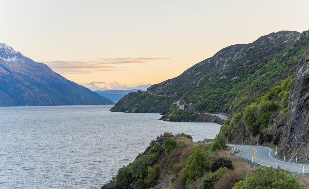 a scenic view of a lake and mountains at sunset