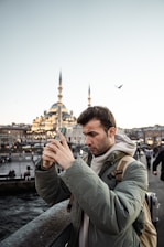 a man taking a picture with his cell phone