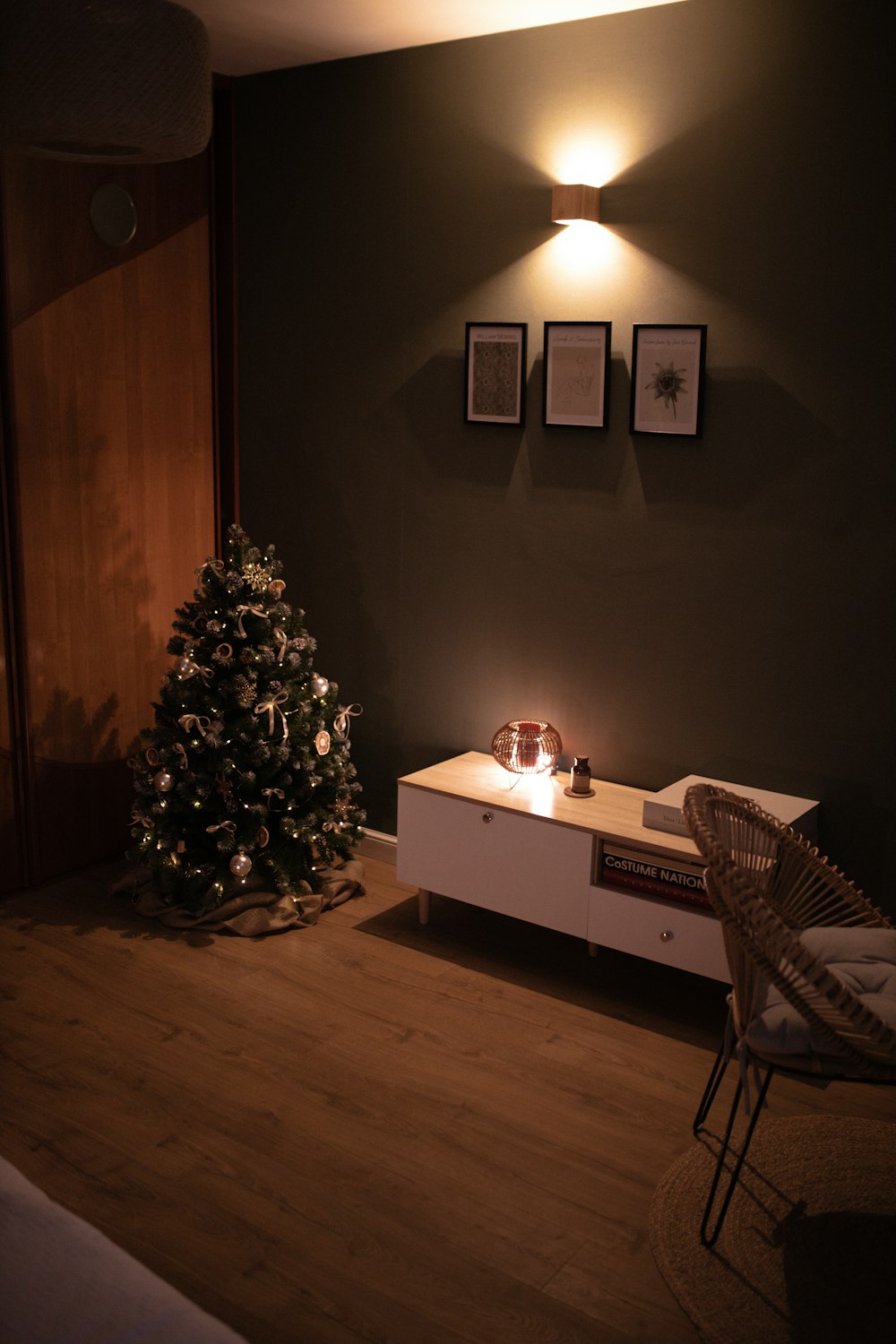 a living room with a lit christmas tree in the corner