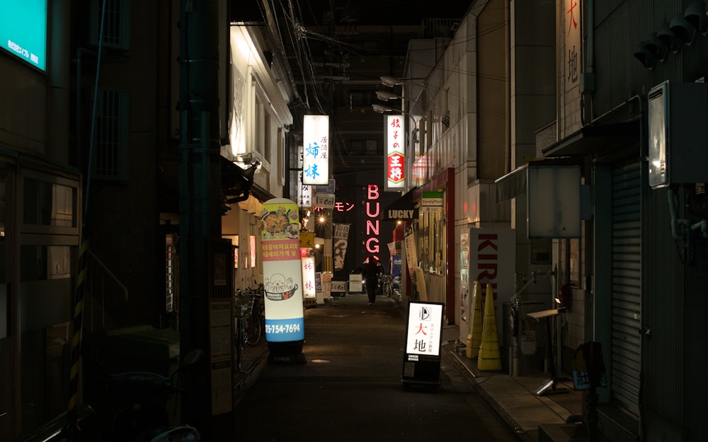 a narrow alley way with signs on both sides
