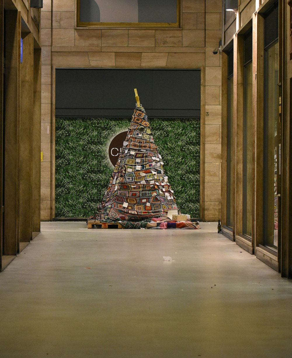 a christmas tree made out of books in a building
