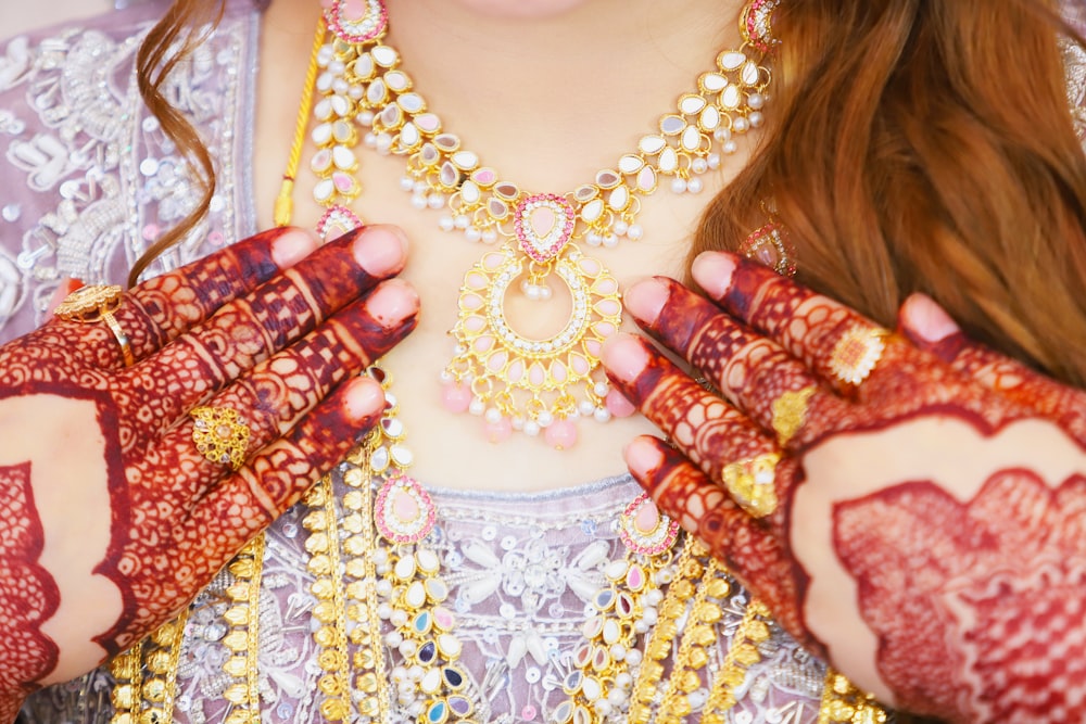 a close up of a woman wearing a necklace and bracelet