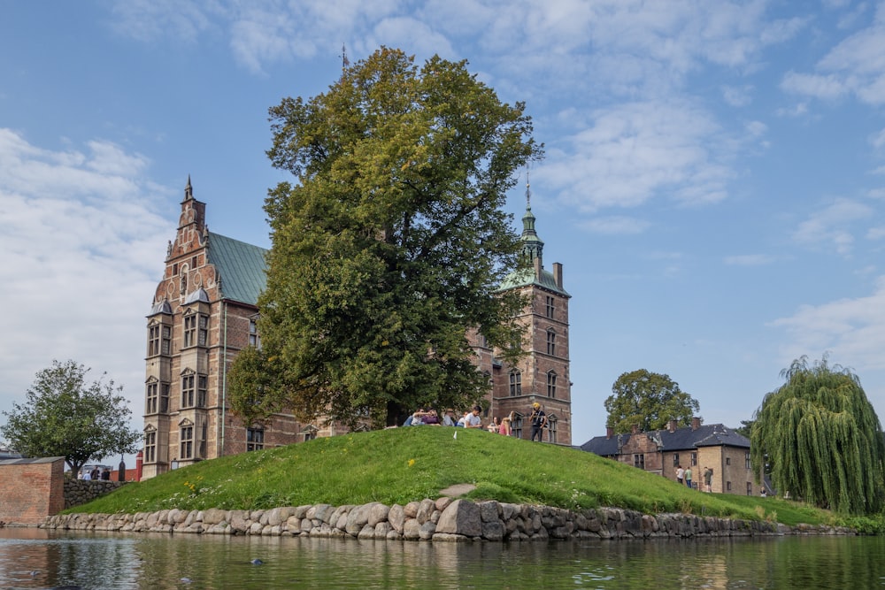 a large building sitting on top of a lush green hillside