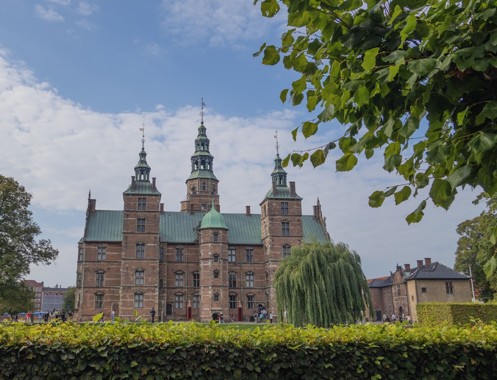 a large brick building with a green roof