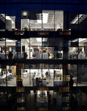 an office building is lit up at night