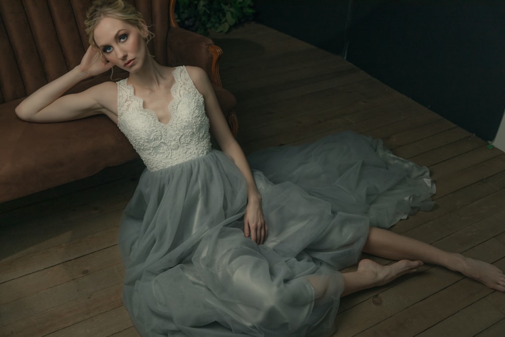 a woman sitting on the floor in a dress