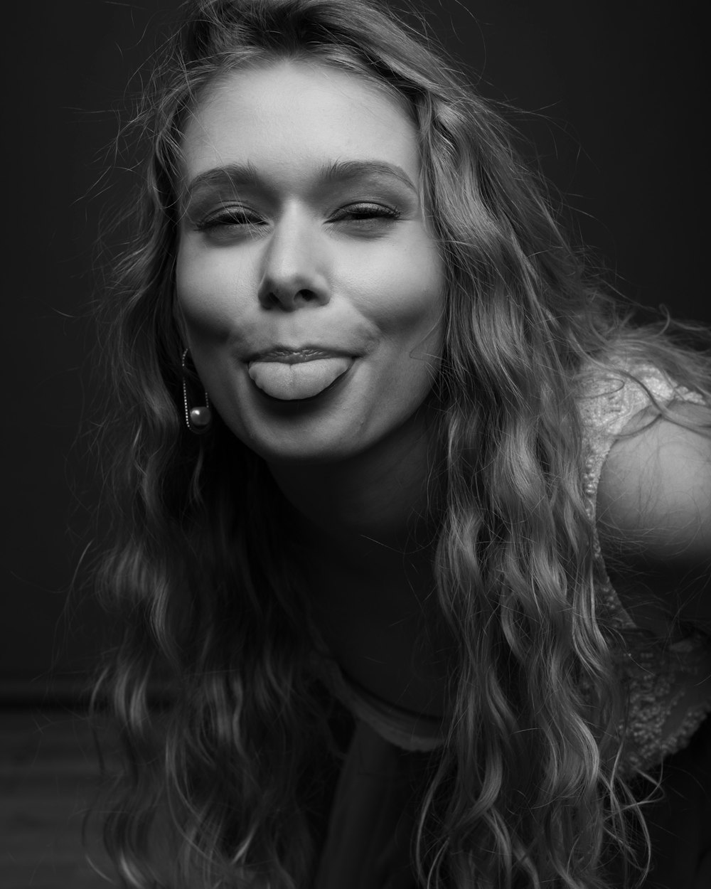 a black and white photo of a woman making a funny face