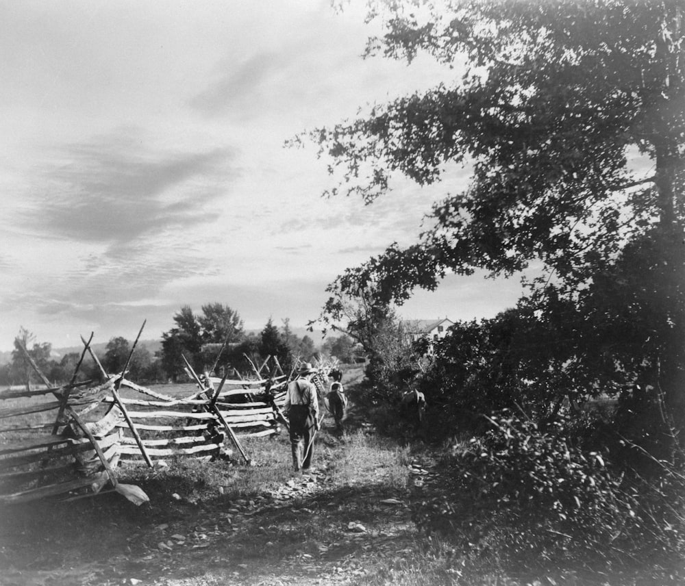 The day's end Summary Farmer and children walking along path next to fence