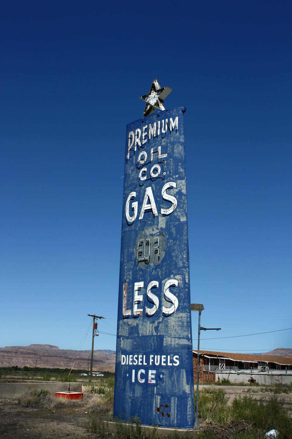 a large blue sign sitting on the side of a road