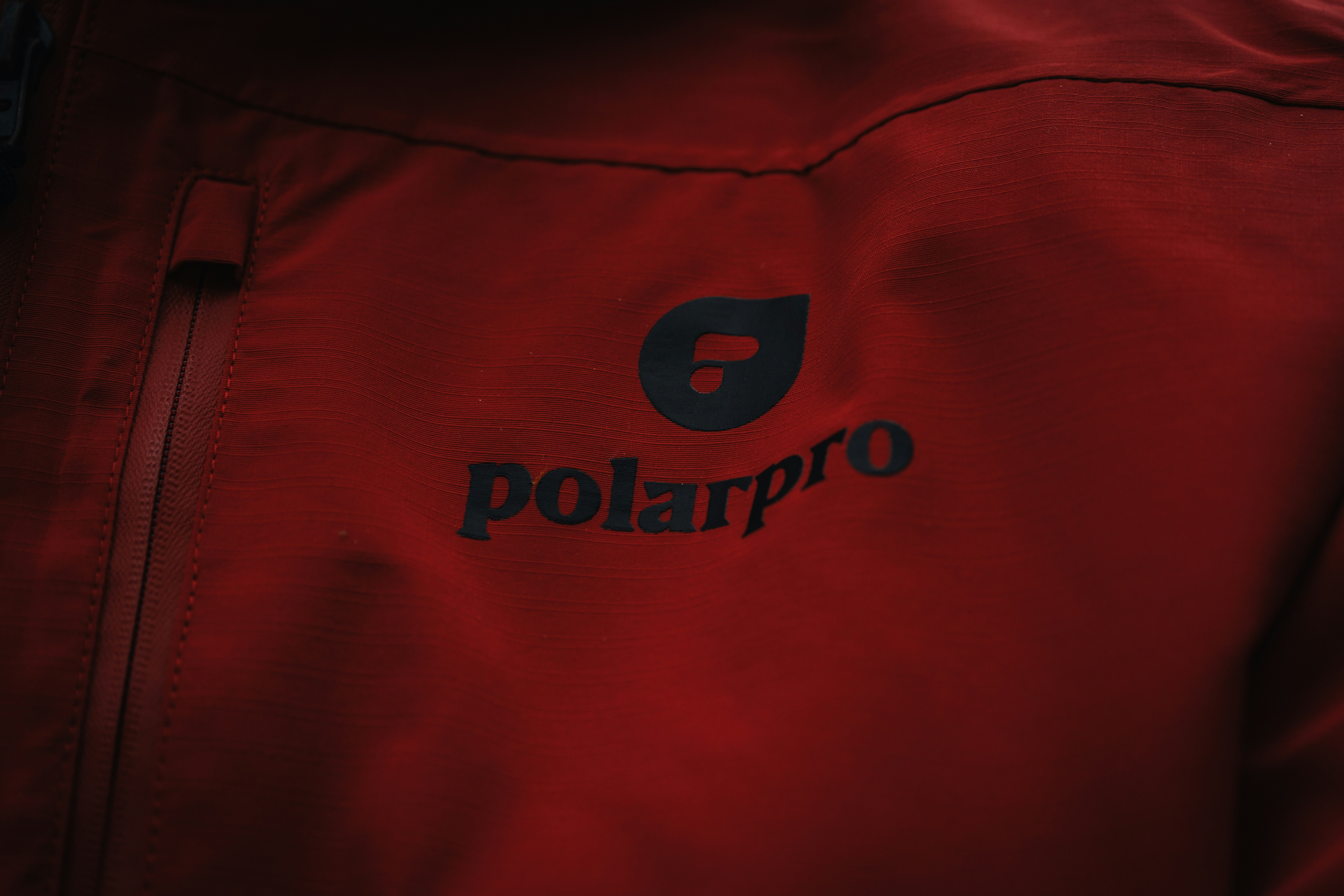 a close up of a person wearing a red jacket