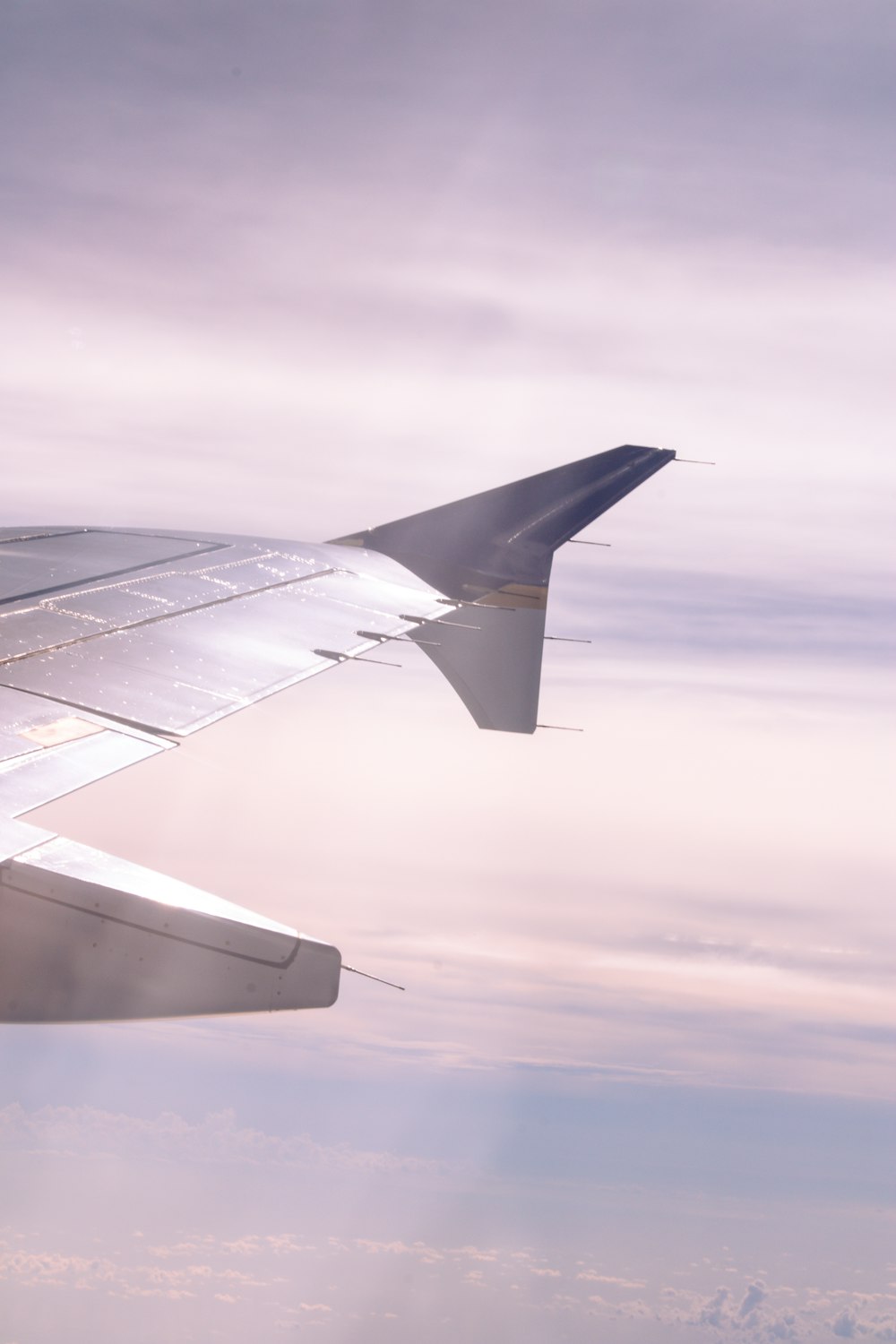 a view of the wing of an airplane in the sky