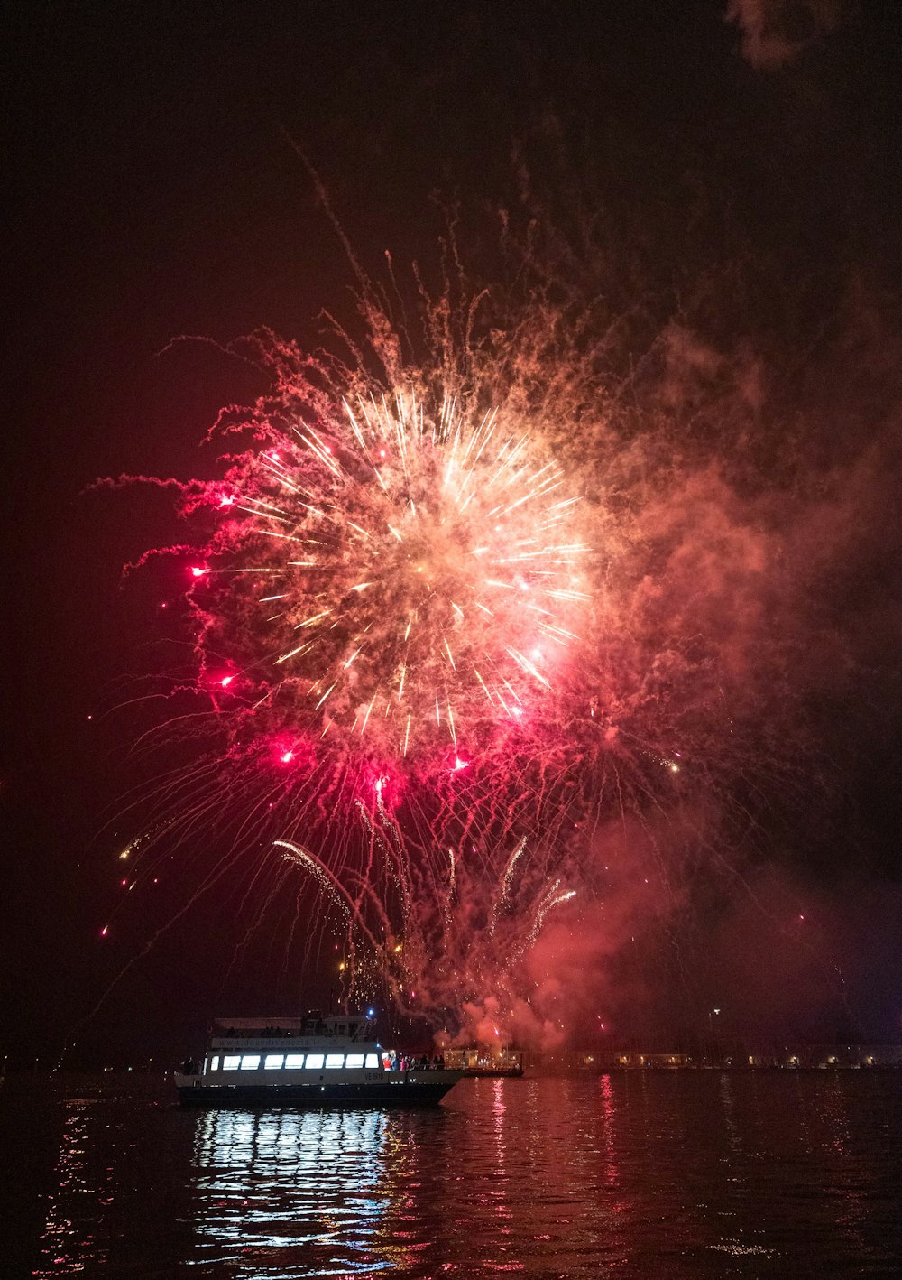 a large fireworks display over a body of water