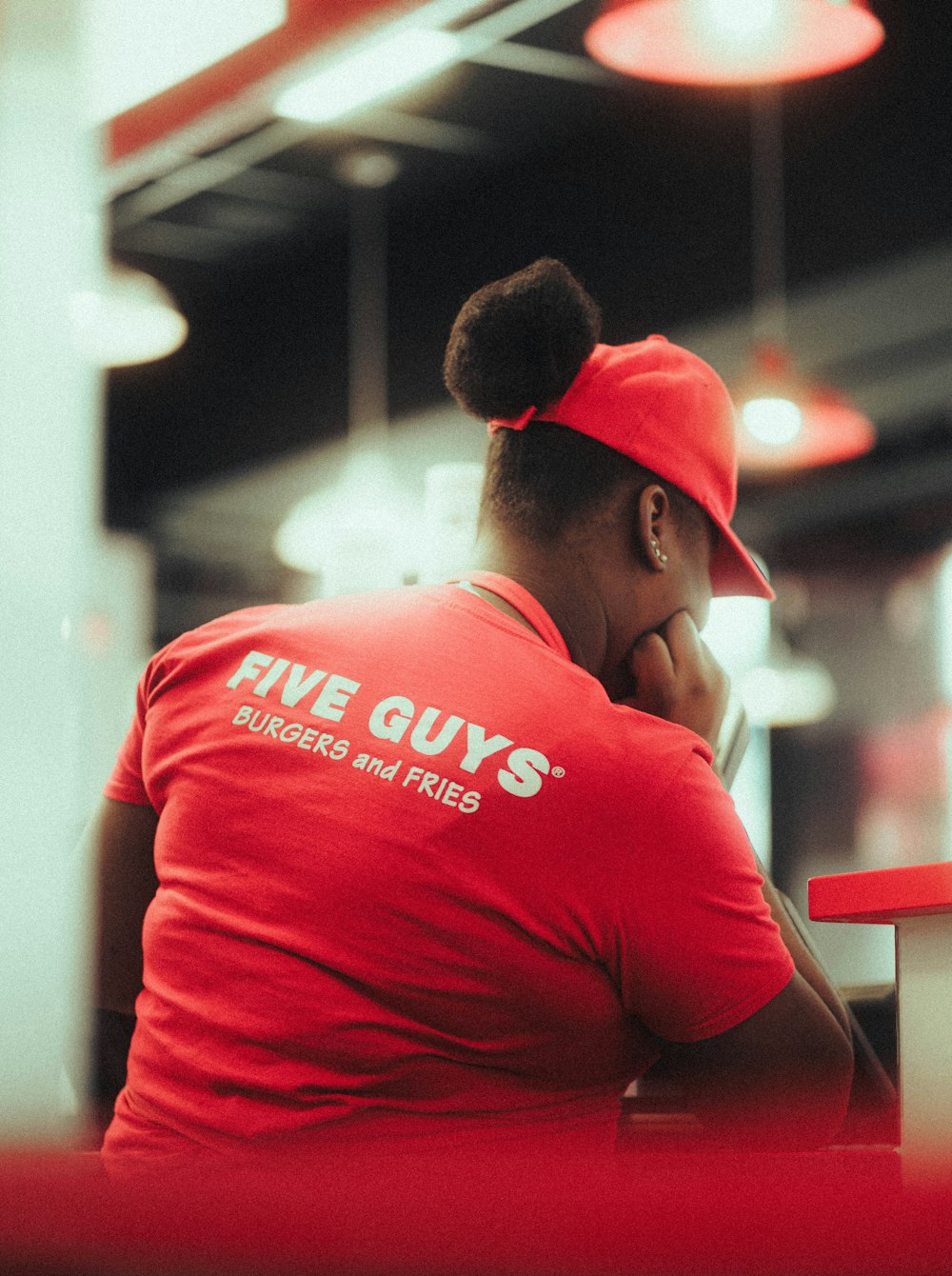 a woman wearing a red shirt and a red hat