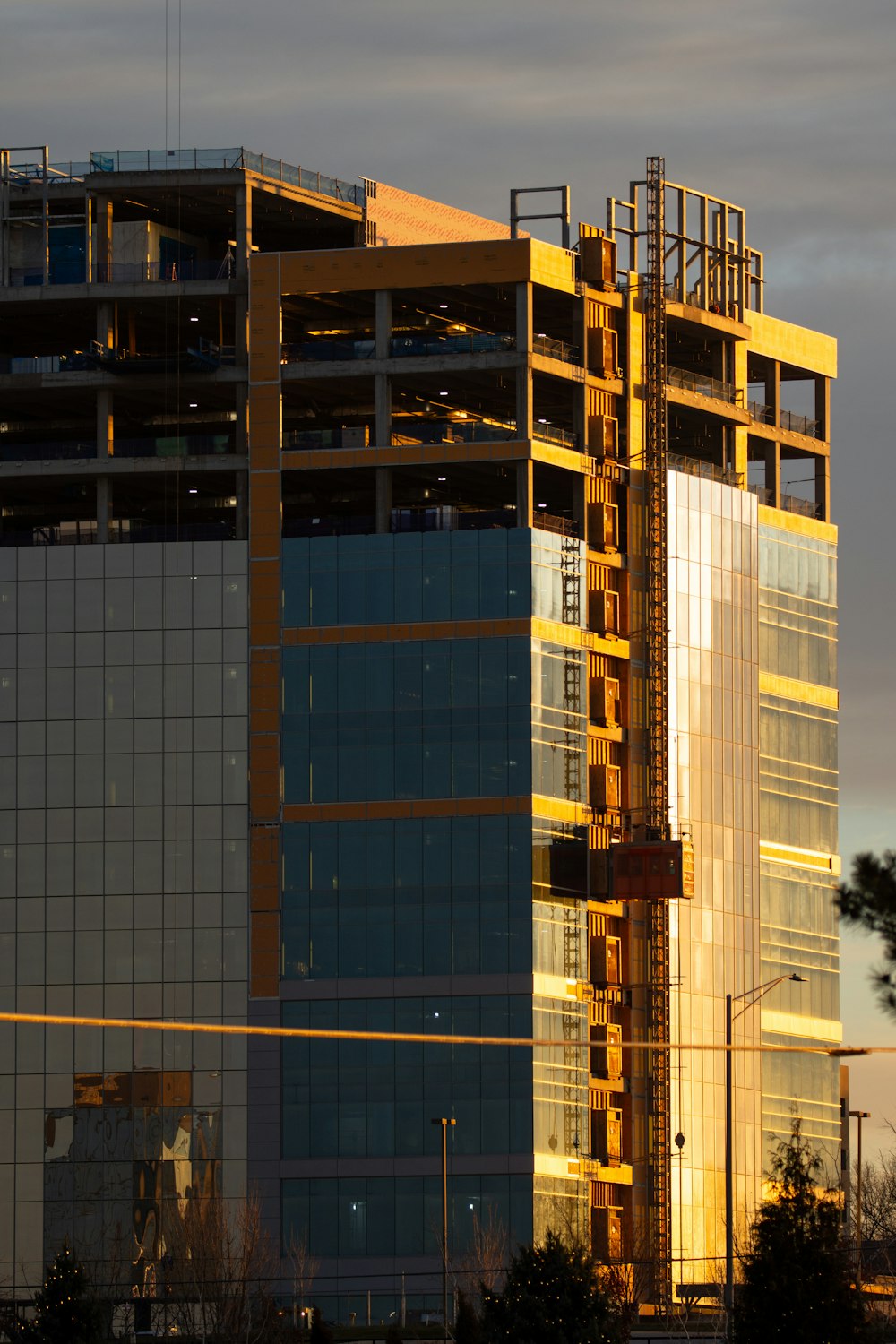 a tall building with a crane in front of it