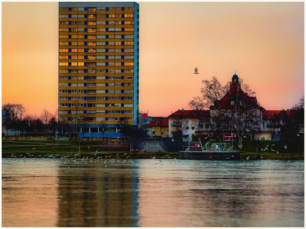 a tall building sitting next to a body of water