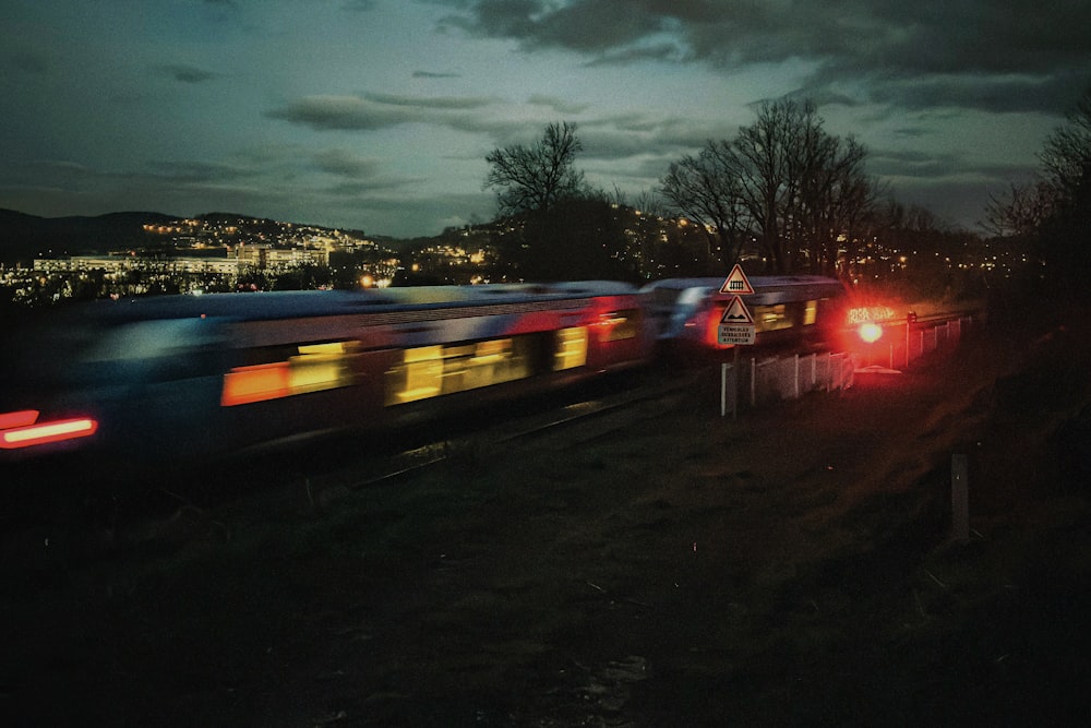 a train traveling down train tracks next to a forest