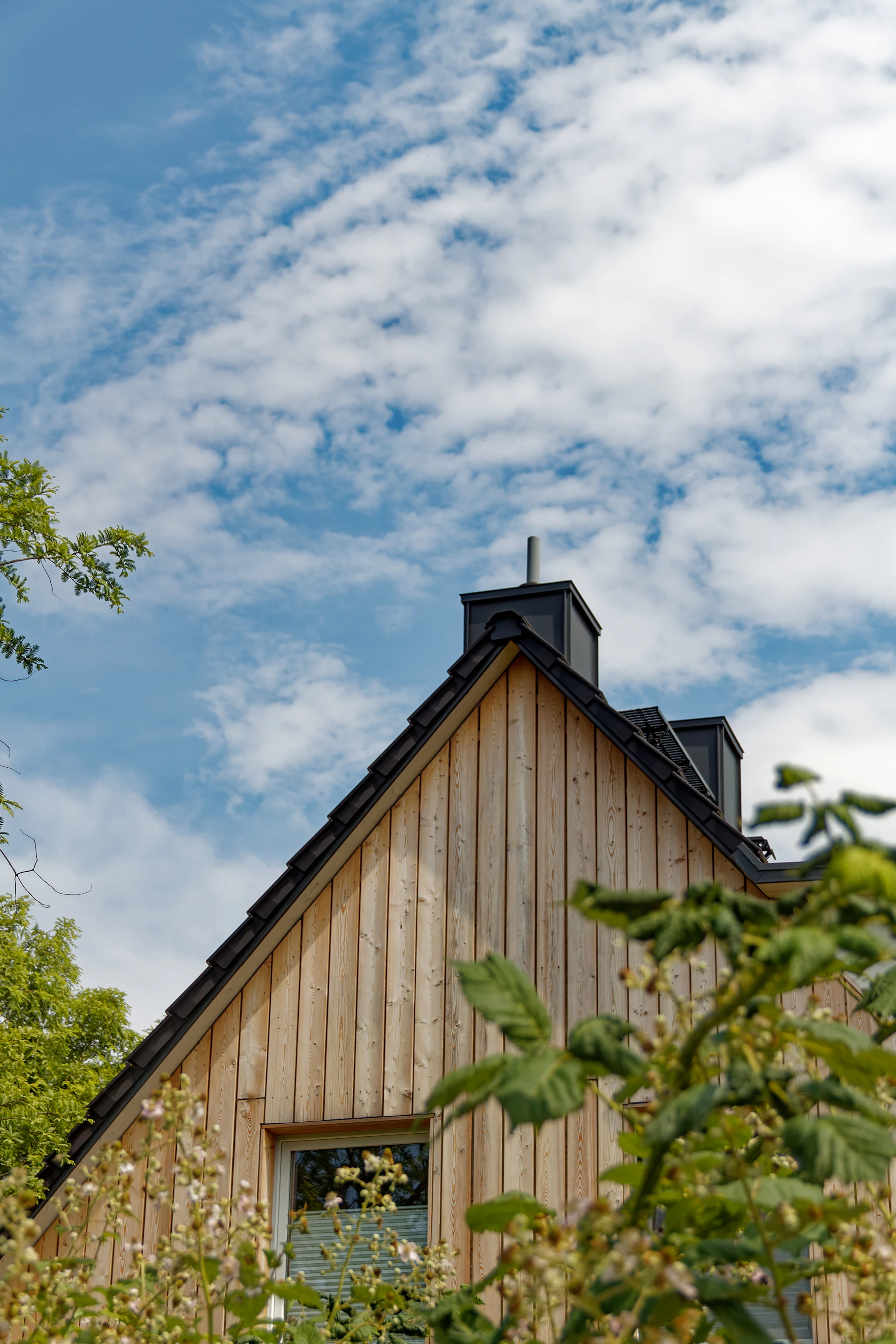 a wooden building with a cross on top of it