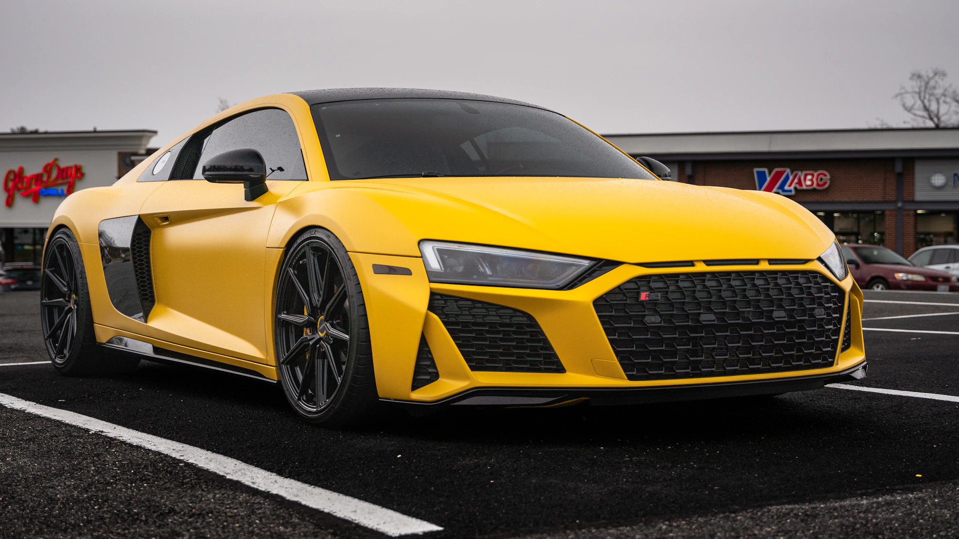 a yellow sports car parked in a parking lot
