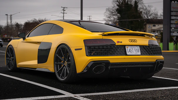 a yellow sports car parked in a parking lot