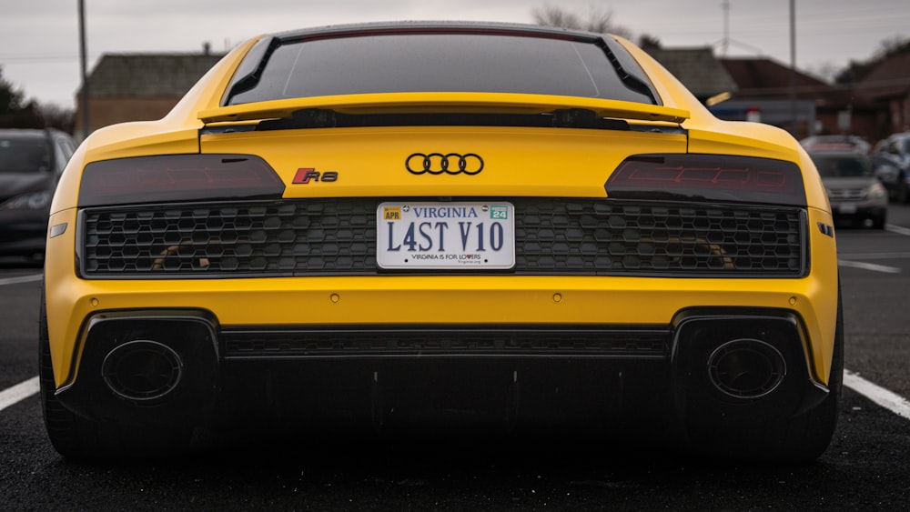 a yellow sports car parked in a parking lot