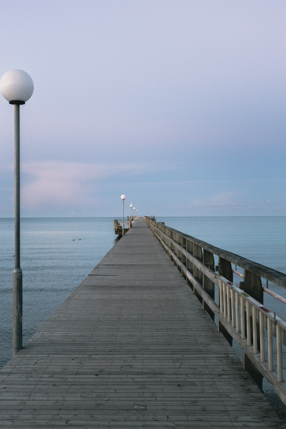 a pier with a light pole and a lamp post