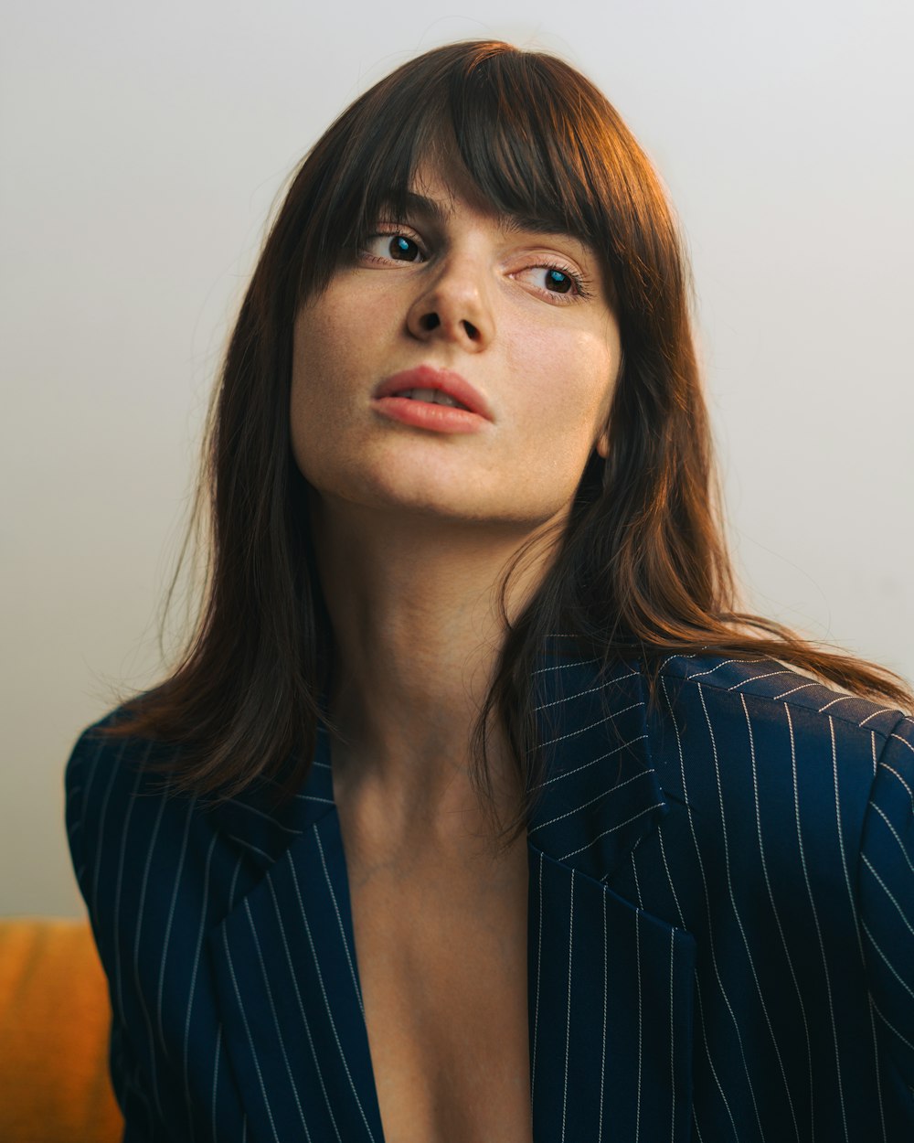a woman in a pinstripe suit poses for a picture