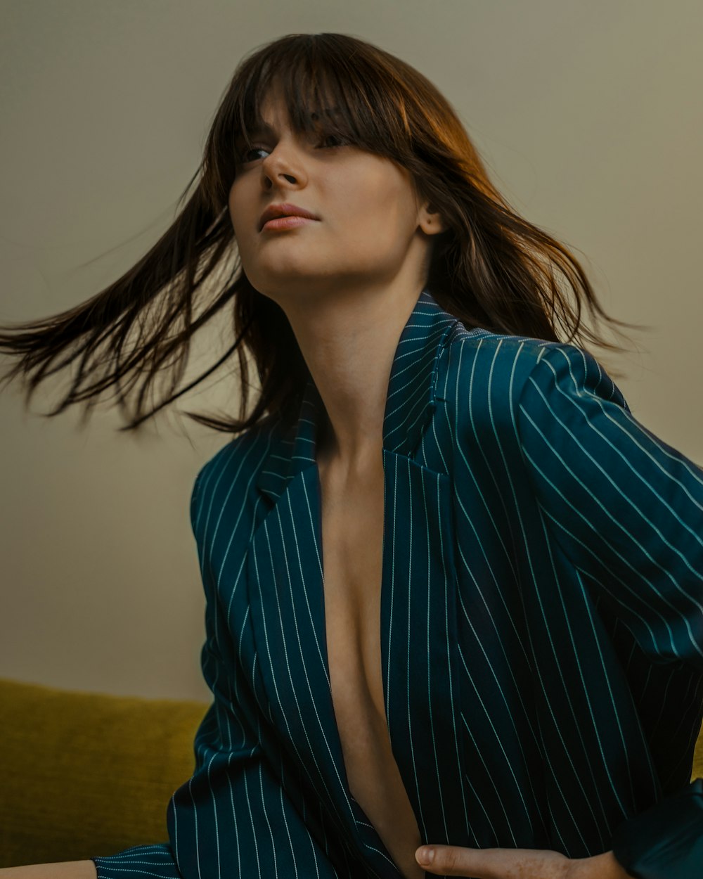 a woman with long hair sitting on a couch