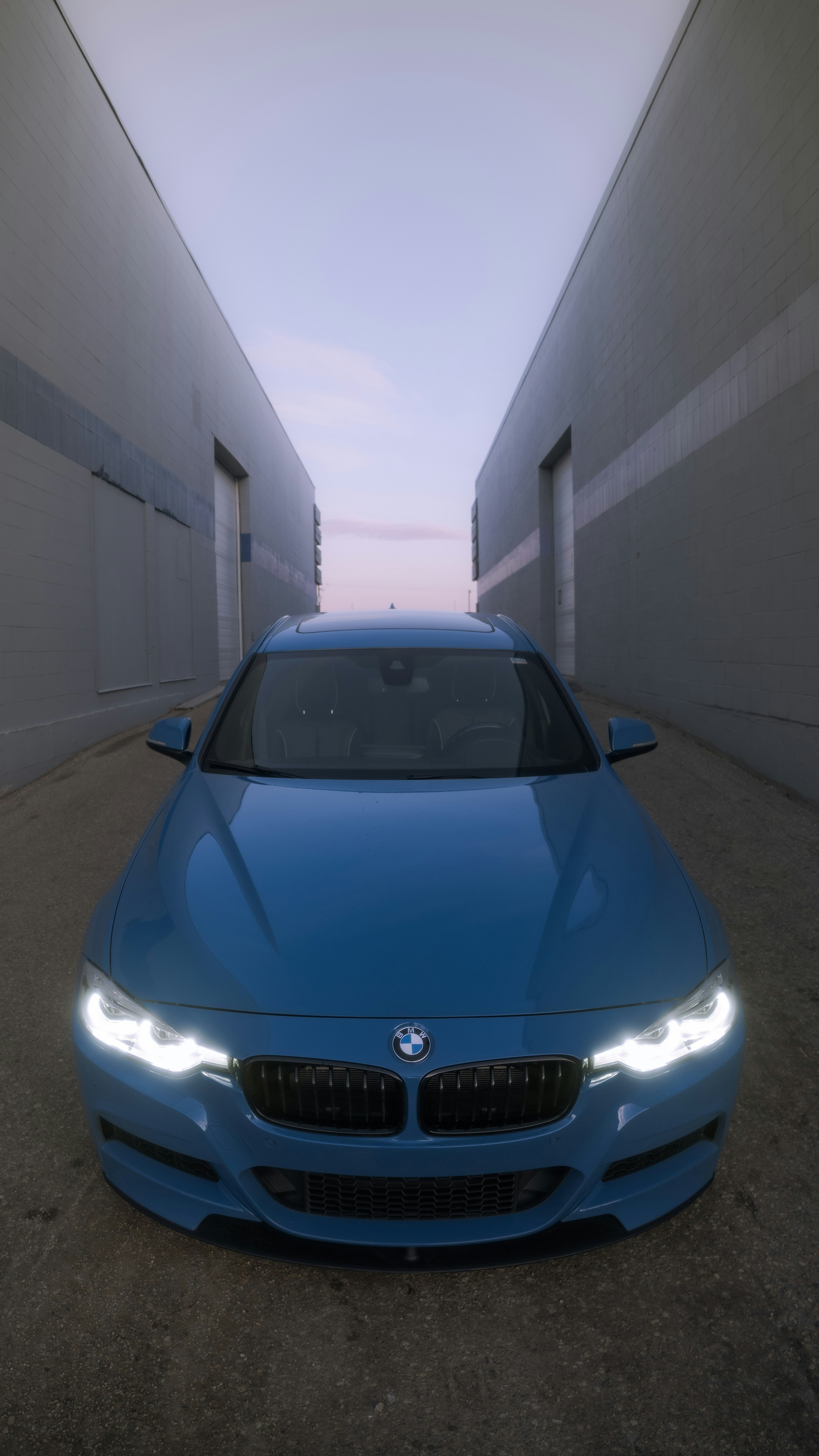 a blue car is parked in a tunnel