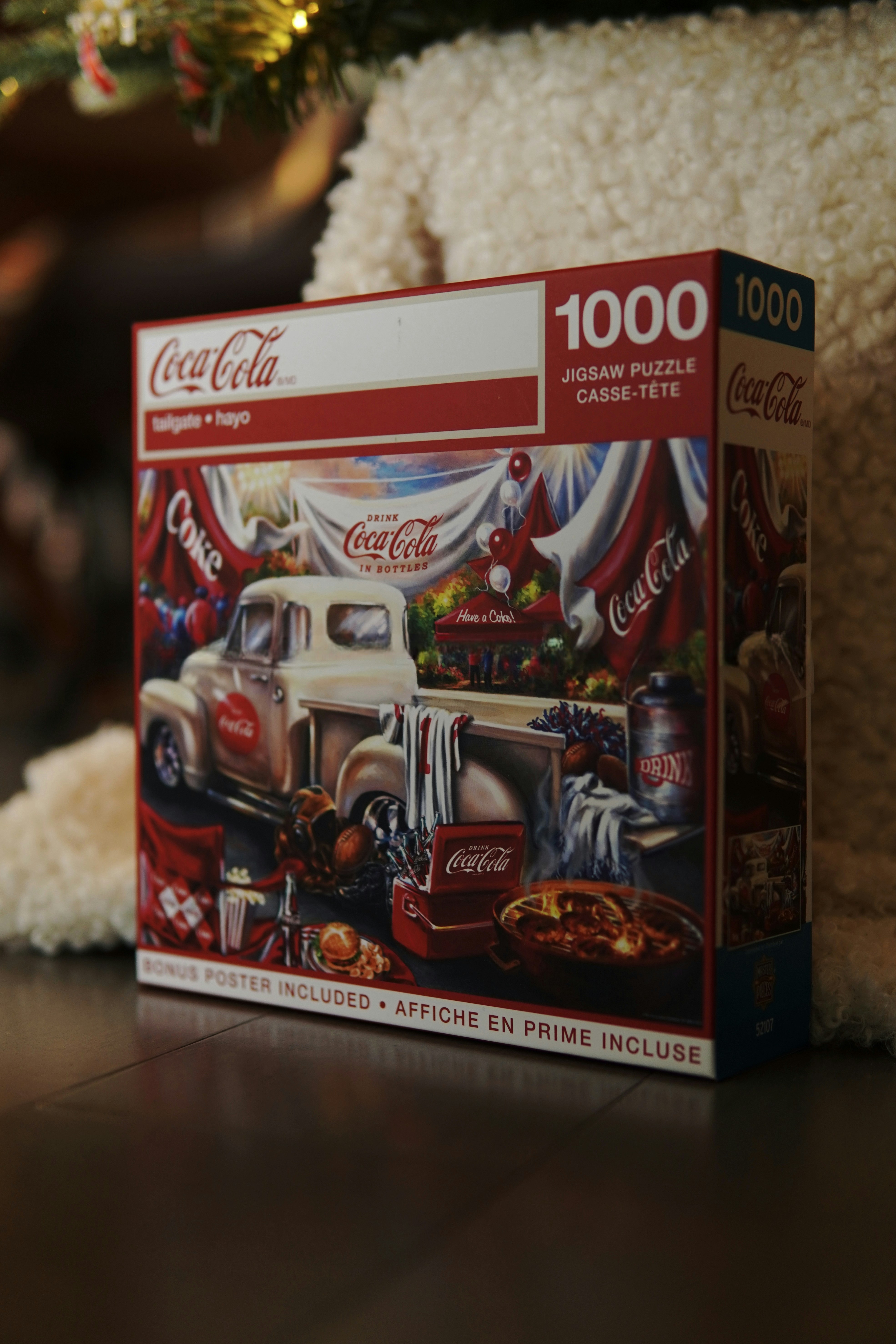 a puzzle box sitting on the floor next to a christmas tree