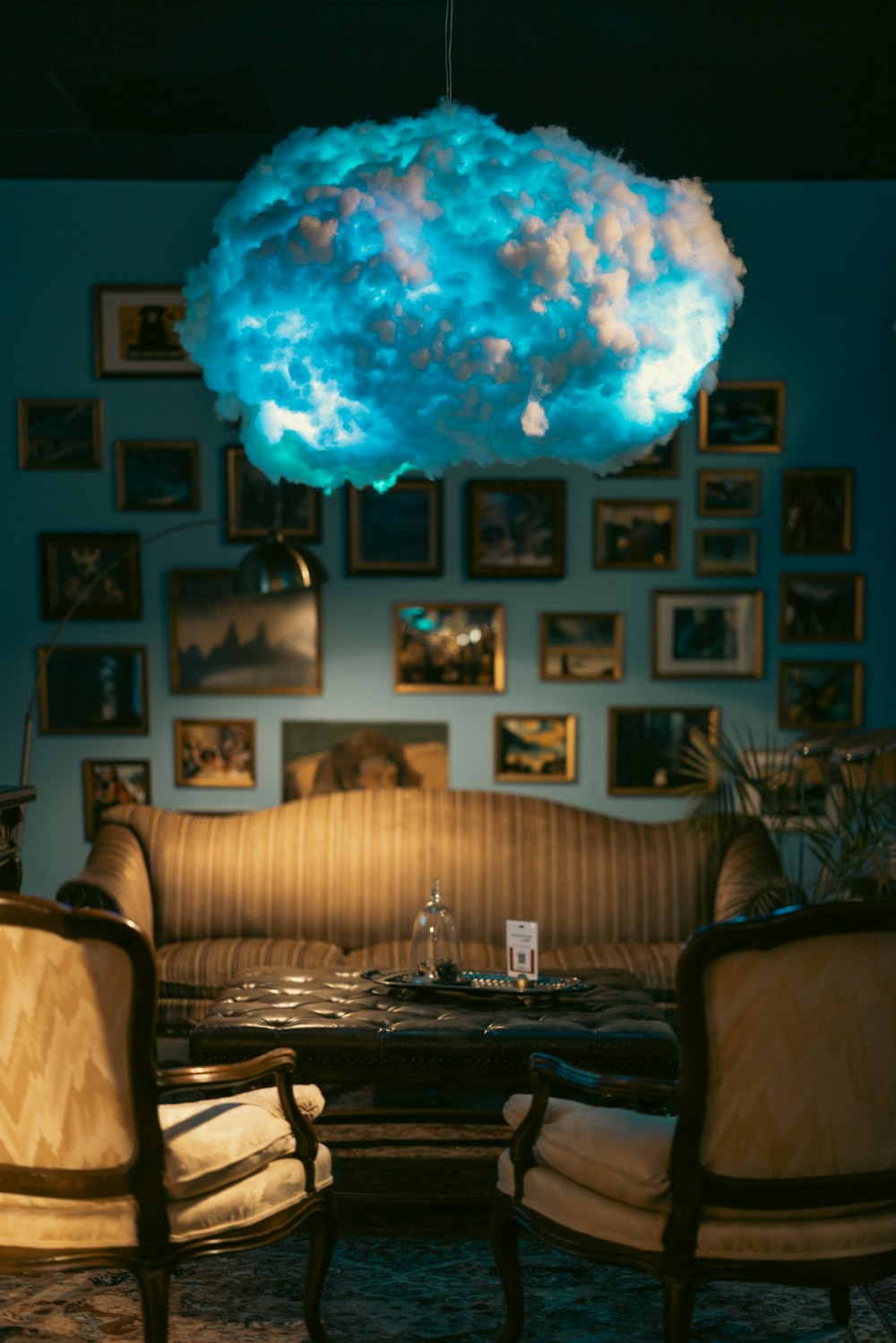 a living room filled with furniture and a large cloud light